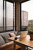 Laptop and cup of coffee on table