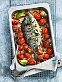 Fish baked with cherry tomatoes and lemons