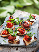 Canapes with grilled cherry tomatoes and ricotta