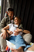 Smiling couple relaxing on hammock