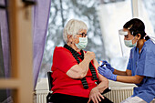 Senior woman getting covid vaccine