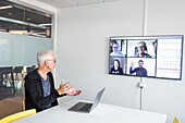 Man in boardroom having video conference
