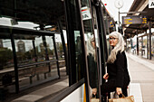 Mature woman entering bus