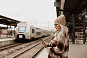 Mature woman at train station
