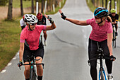 Happy cyclists giving each other high five