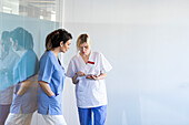 Female nurse and doctor checking file