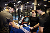 Group of friends playing padel at indoor court