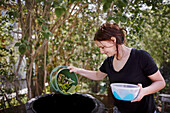 Woman throwing out organic waste