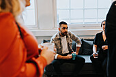 Smiling coworkers talking at break time