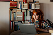 Woman in living room using laptop
