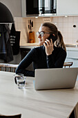 Smiling woman talking via cell phone