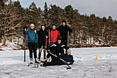 Friends standing on frozen lake