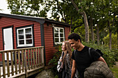 Smiling couple at wooden cabin