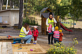 Preschool teachers with students at playground