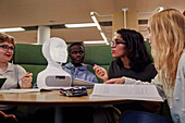 Friends sitting together in library