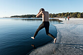 Man jumping into freezing cold water