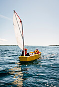 Man and boy in small sailing boat
