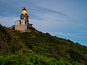 Old-fashioned lighthouse on hill