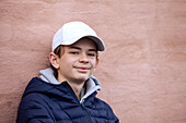 Portrait of smiling teenage boy in baseball cap