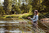 Woman fishing in lake