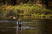 Woman fishing in lake