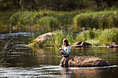 Woman fishing in lake