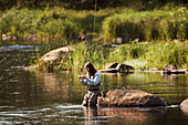 Woman fishing in lake