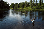 Woman fishing in river