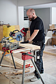 Man working with electric saw
