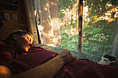 Young man sleeping in camper van