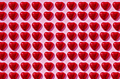 Heart-shaped candy on pink background