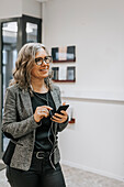 Smiling woman holding cell phone