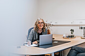 Smiling woman sitting in office