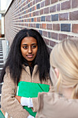 Female students standing outdoors and talking