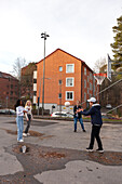 Teenage friends playing basketball outdoors