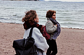 Female friends walking on beach
