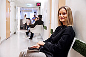 Young female patient waiting in outpatient clinic