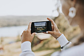 Woman taking photo with cell phone