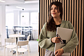 Smiling woman holding laptop