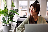 Woman looking through window