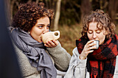 Female friends drinking hot drinks