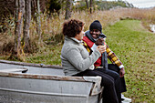 Friends sitting on old boat and talking