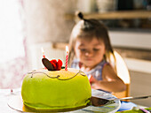 Birthday cake, girl in background