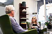 Senior man and woman talking over coffee