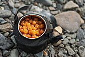 Cloudberries in metal kettle