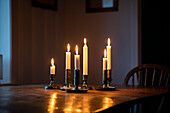 Lit candles on wooden table
