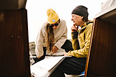 Women looking at map on boat