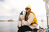 Woman holding fender on boat