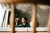 Young woman drinking coffee at home