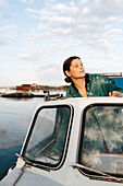 Young woman driving motorboat